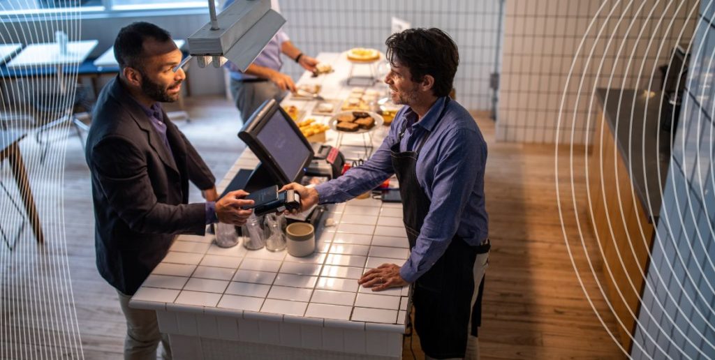 Someone paying in a cafe